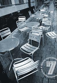 Rain-soaked chairs and tables outside a Manchester cafe-bar.